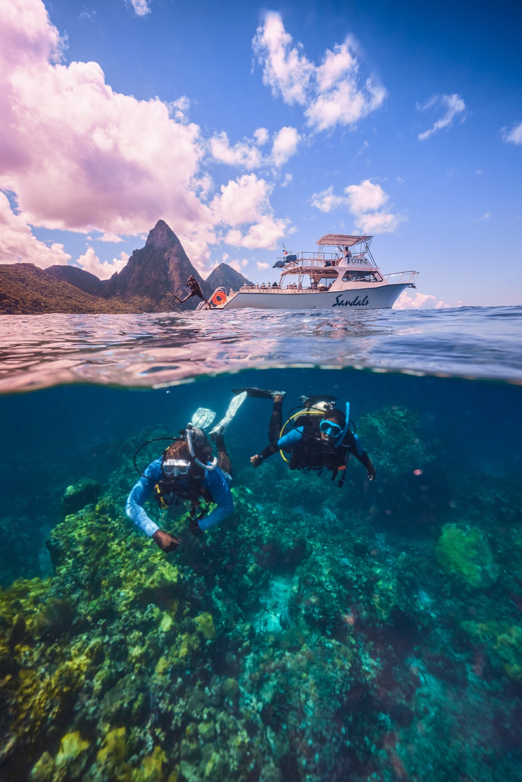 A sunny split view of reef below and green islands above