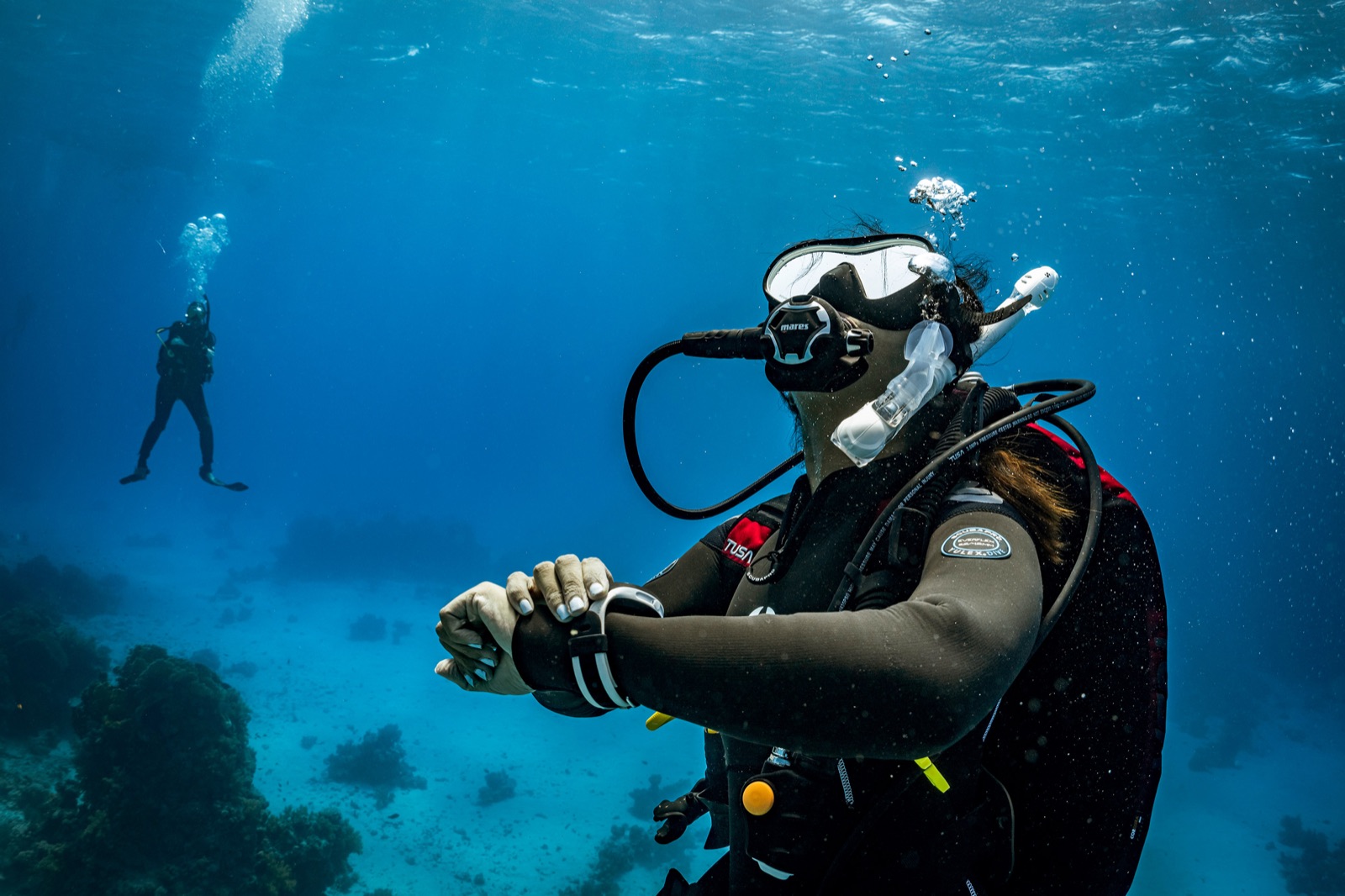 Divers exploring together in open water